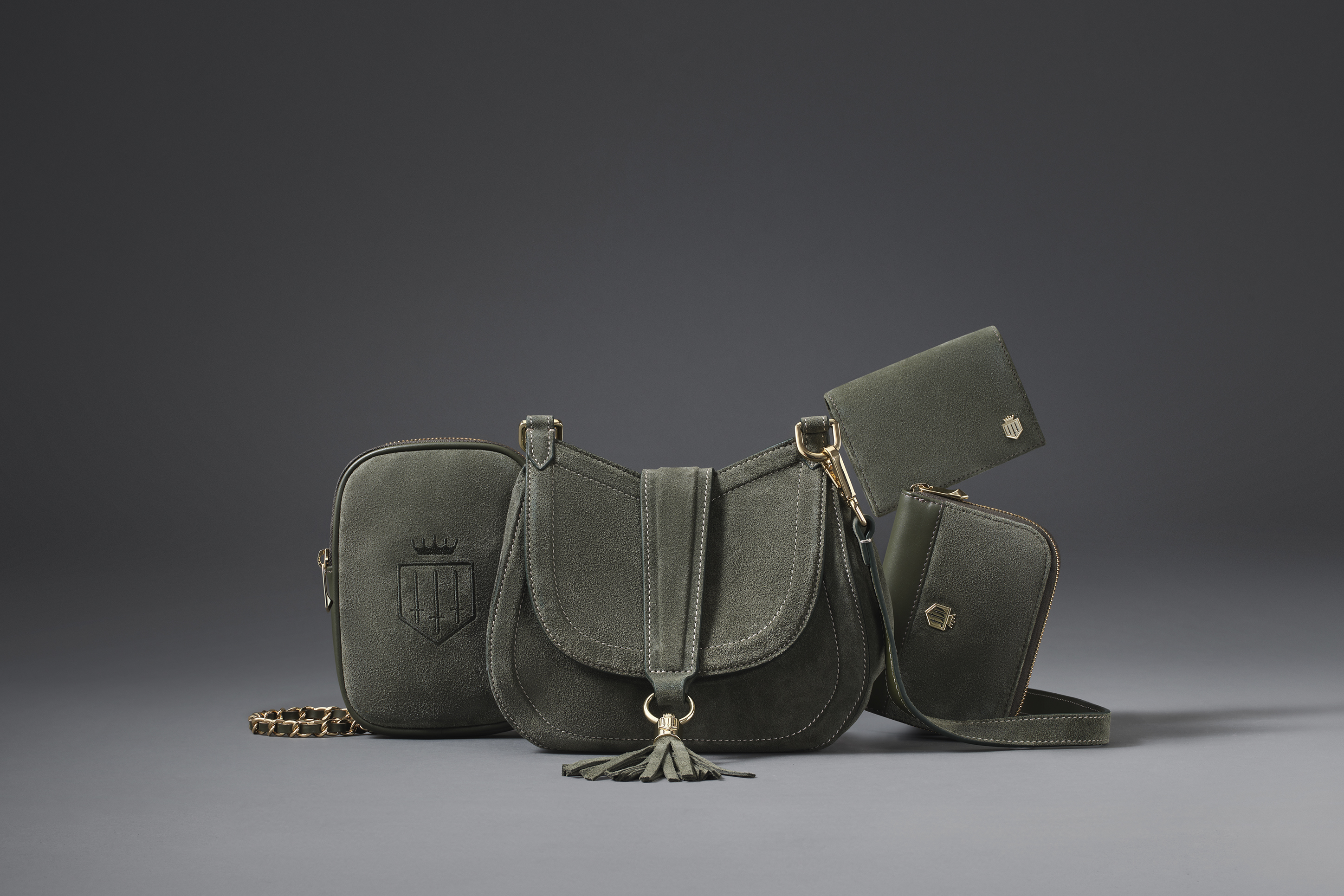 advertising photo shoot A/W for Fairfax and favor green handbag on dark grey backdrop